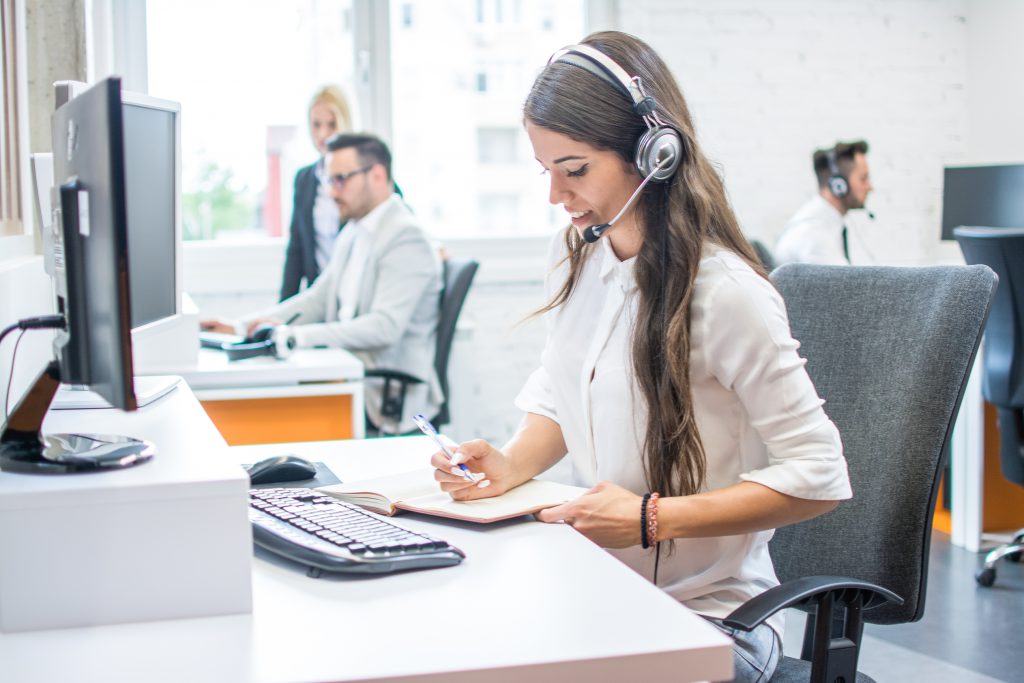 Woman sitting at desk with headset