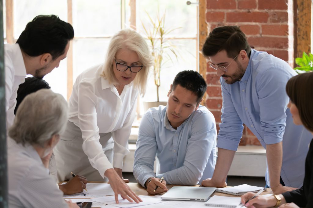 mixed gender team working together with senior female lead