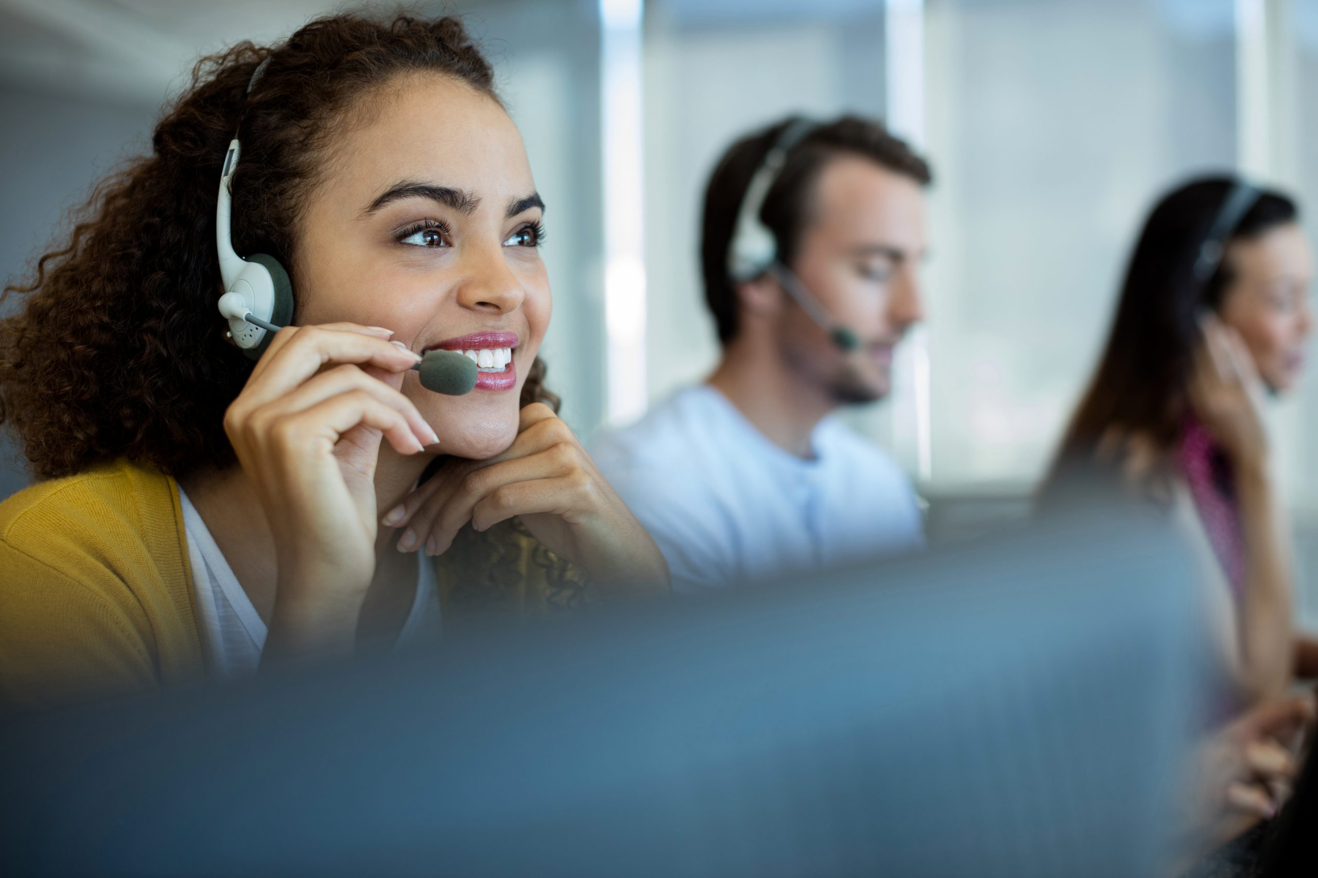 young female at call centre on phone call with client 