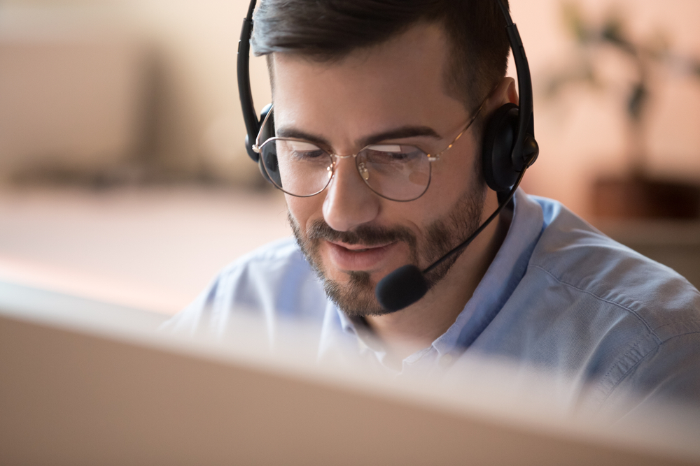 close up of professional male in office speaking on headset 