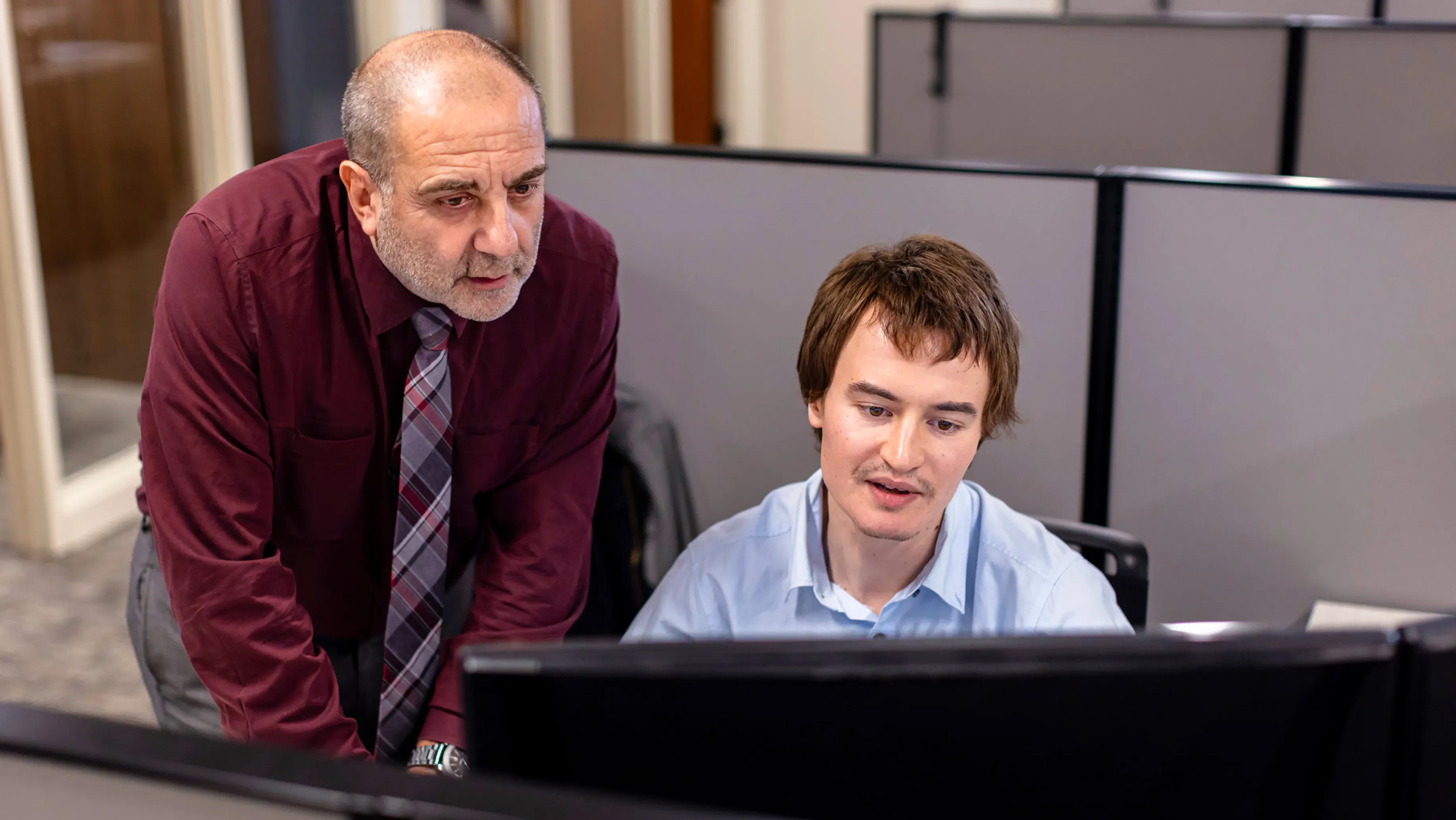 Photo of two team members discussing debt collection negotiation 